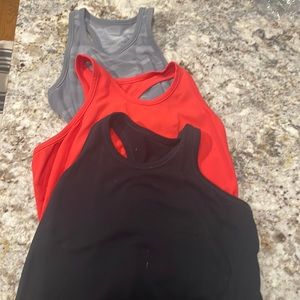 3 barely worn Athleta tanks- size 0 or 2, could be worn as kids 14 probably